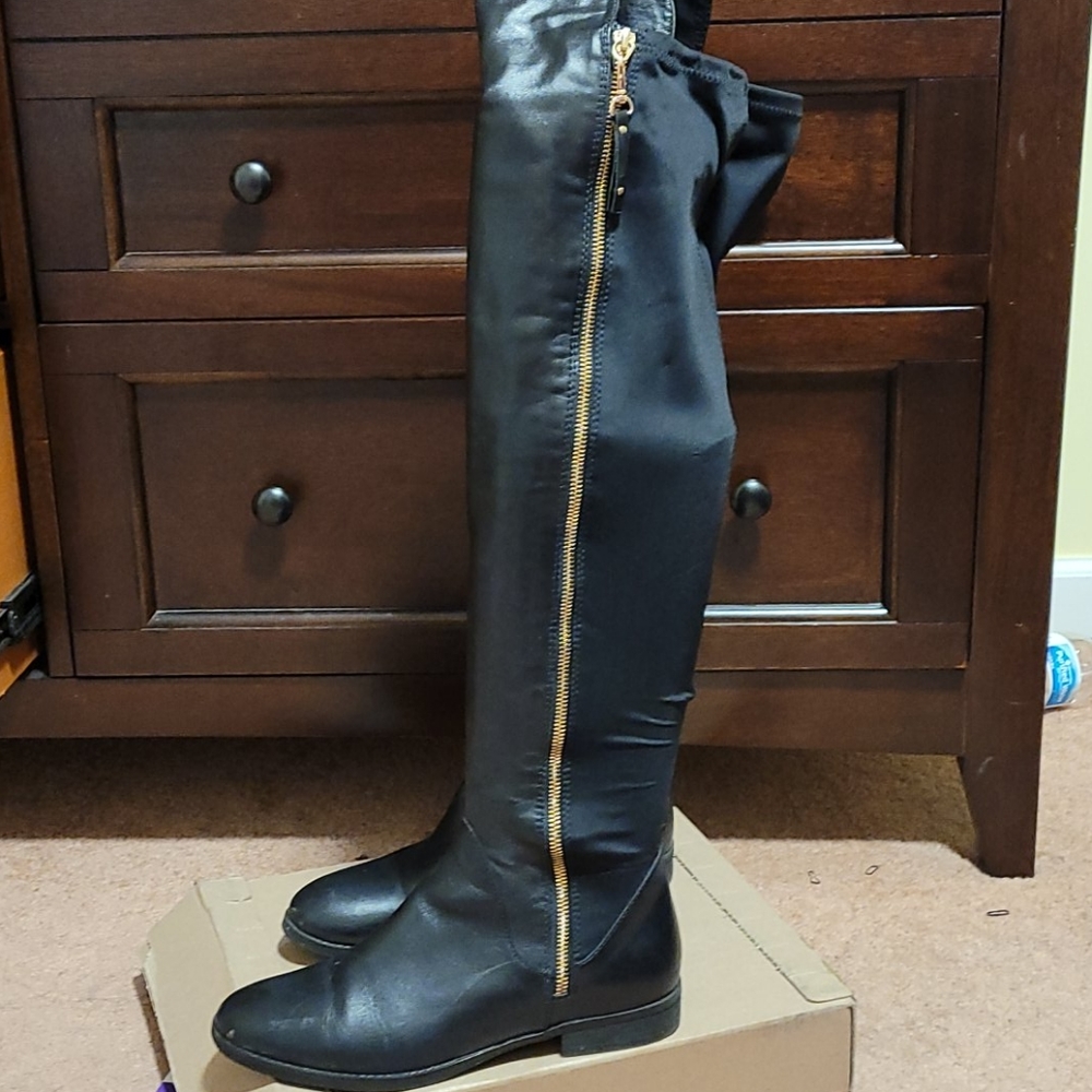 Black leather OTK boots with gold zipper detail